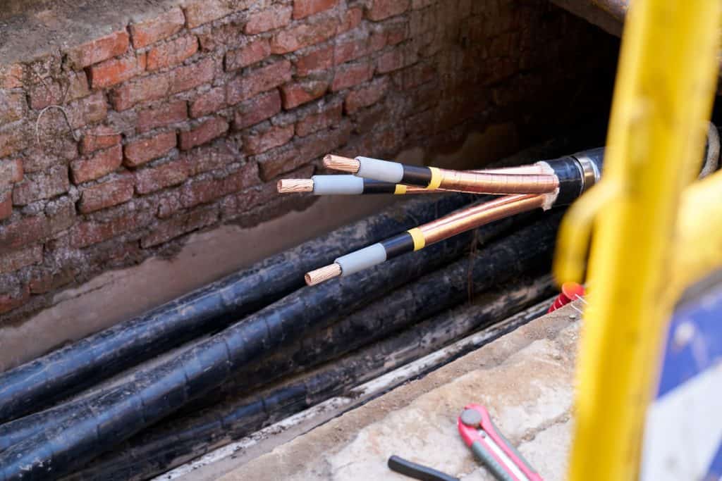 technician repairs coper wire an Underground cable line Electrical